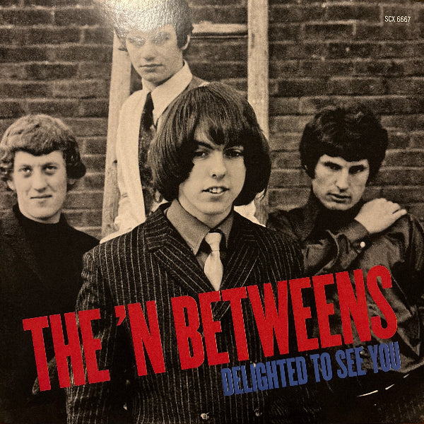 Album cover of 'The 'N Betweens' with a black and white photo of four people on a wooden floor.