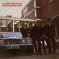Album cover of 'Shake Some Action' by Flamin' Groovies with four men standing in front of a car.