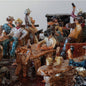 Close-up of detailed figurines in a scene with a white background