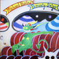 Colorful illustration of a green creature on red pumpkins with text at the top.