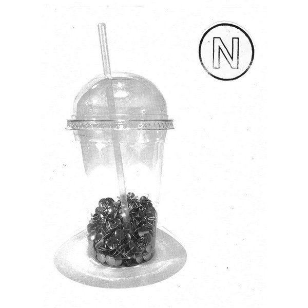 A clear plastic dome cup with a straw, filled with dark candy or beads, on a white background with a black circle containing the letter 'N' in the upper right.