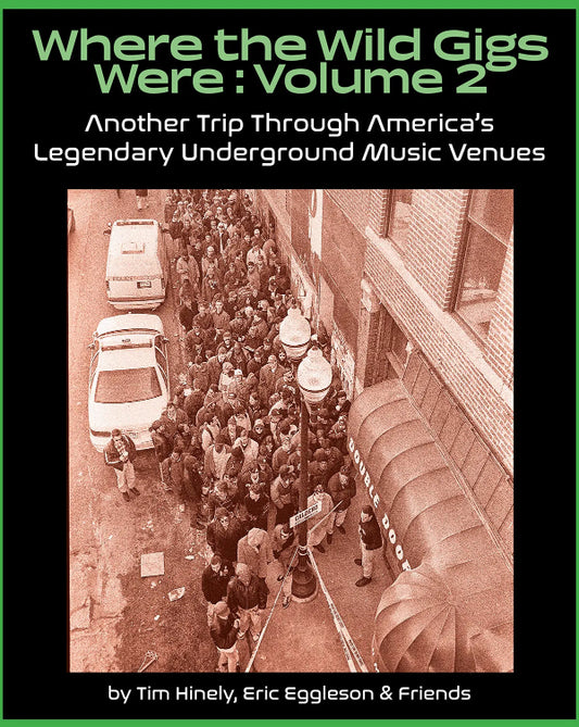 Book cover for 'Where the Wild Gigs Were : Volume 2' featuring a black background with green title text and a sepia-toned photograph of a crowded street scene in front of a music venue.