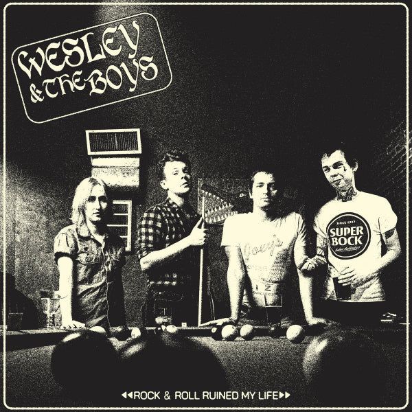The band standing behind a pool table with a game in progress