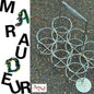 Metallic decorative object on a textured surface with 'Mau德' branding.