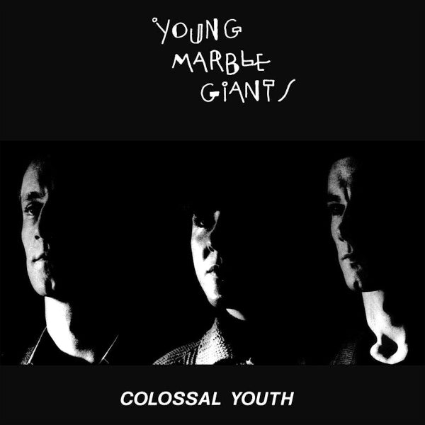 The three members of the band in the shadows with one side of their face highlighted surrounded by black. Young Marble Giants scrawled in a hand drawn font